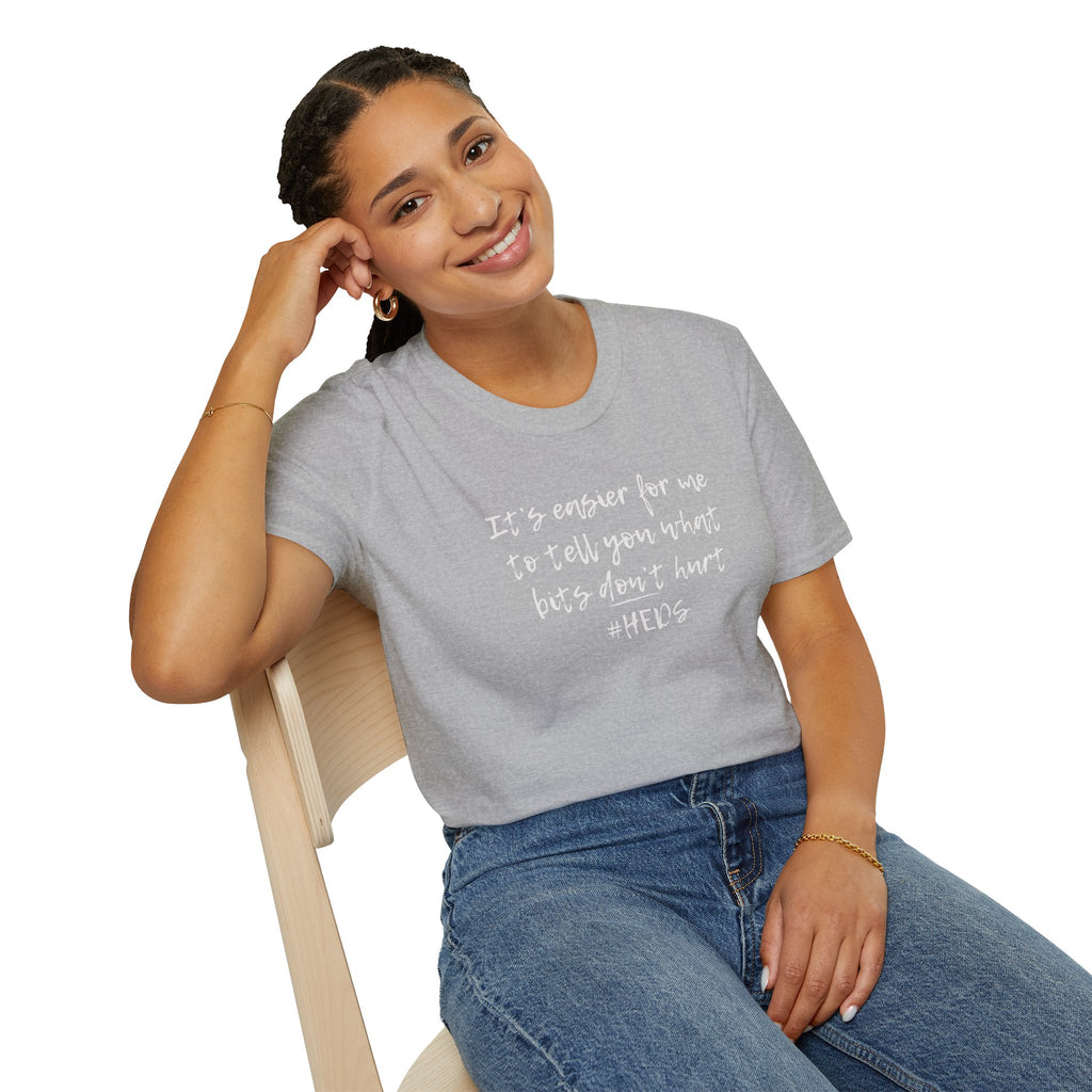 Woman wearing a gray t-shirt with text sitting on a chair against a white background