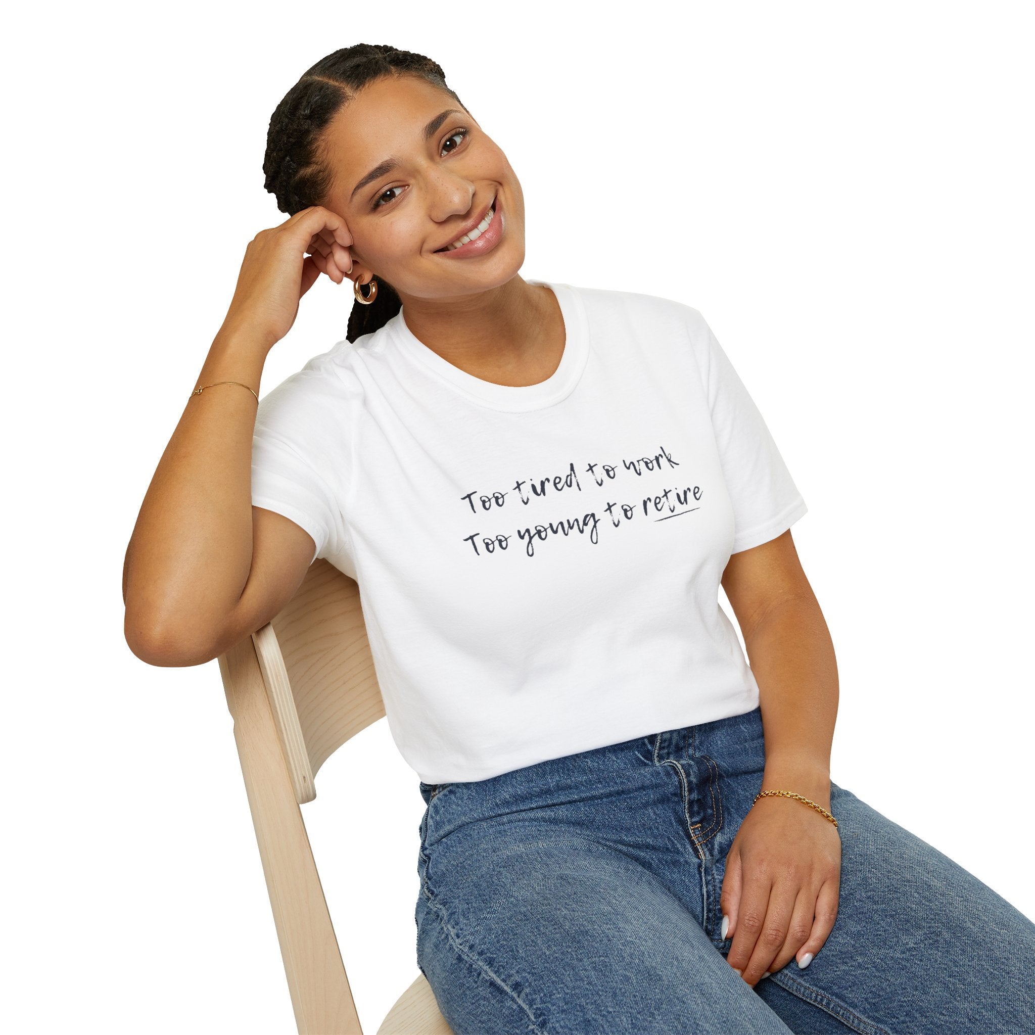 Woman wearing a white t-shirt with 'too tired to work, too young to retire' text, sitting on a chair against a white background