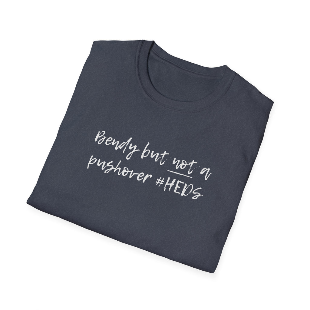 Folded black t-shirt with 'bendy but not a pushover.' text on a white background