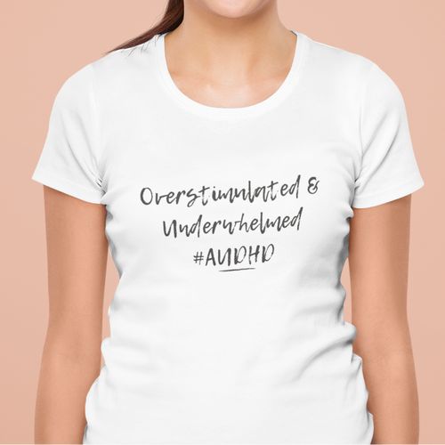 A person wearing the relaxed-fit "Overstimulated and Underwhelmed" shirt. Soft, breathable apparel designed for neurospicy adults navigating a sensory-heavy world.