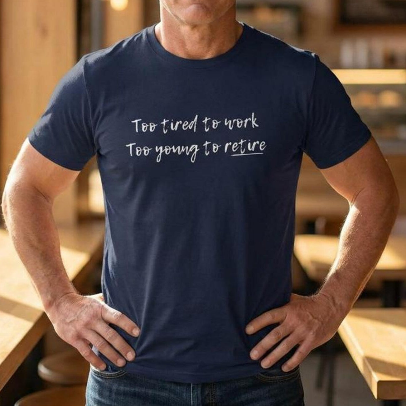 Man wearing a navy blue t-shirt with text in a casual setting