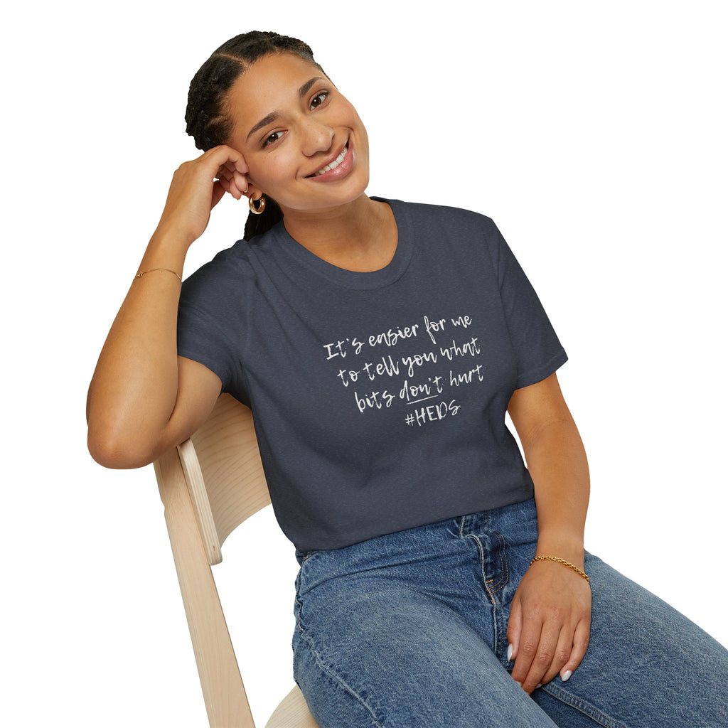 Woman wearing a navy blue t-shirt with pretty bold print graphic sitting on a chair.