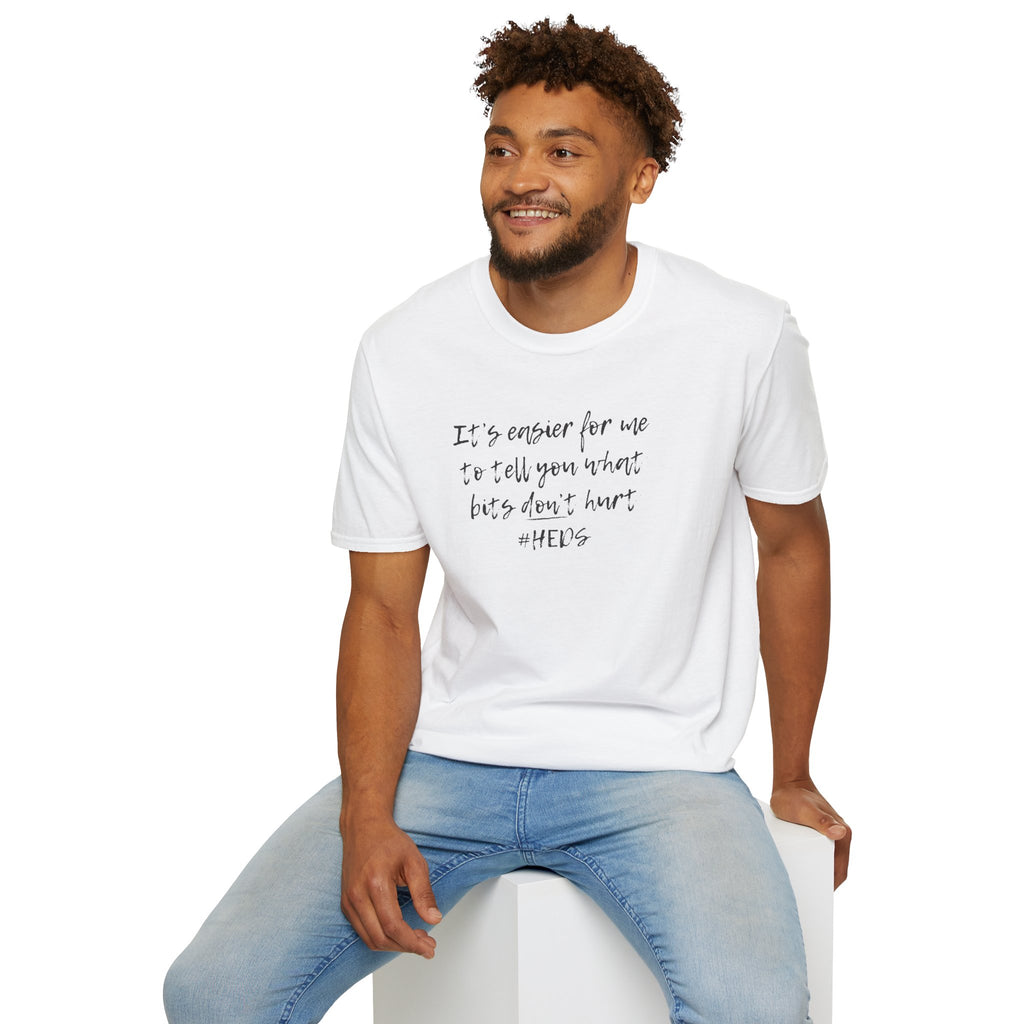 Man wearing a white t-shirt with "What Bits Don't Hurt" shirt. sitting on a white stool against a white background